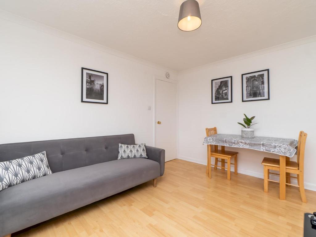 a living room with a couch and a table at Pass the Keys One bed flat with stunning views and free parking in Bath