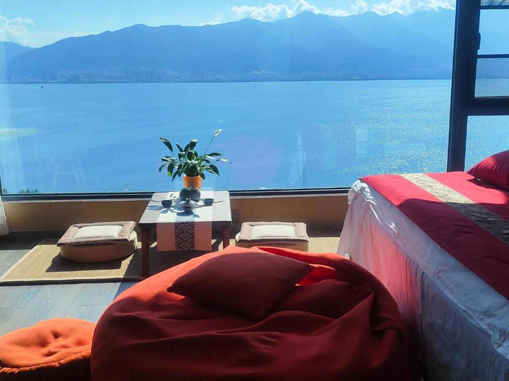 a bedroom with a large window with a view of the ocean at Super Invincible All Seaview Villa in Dali