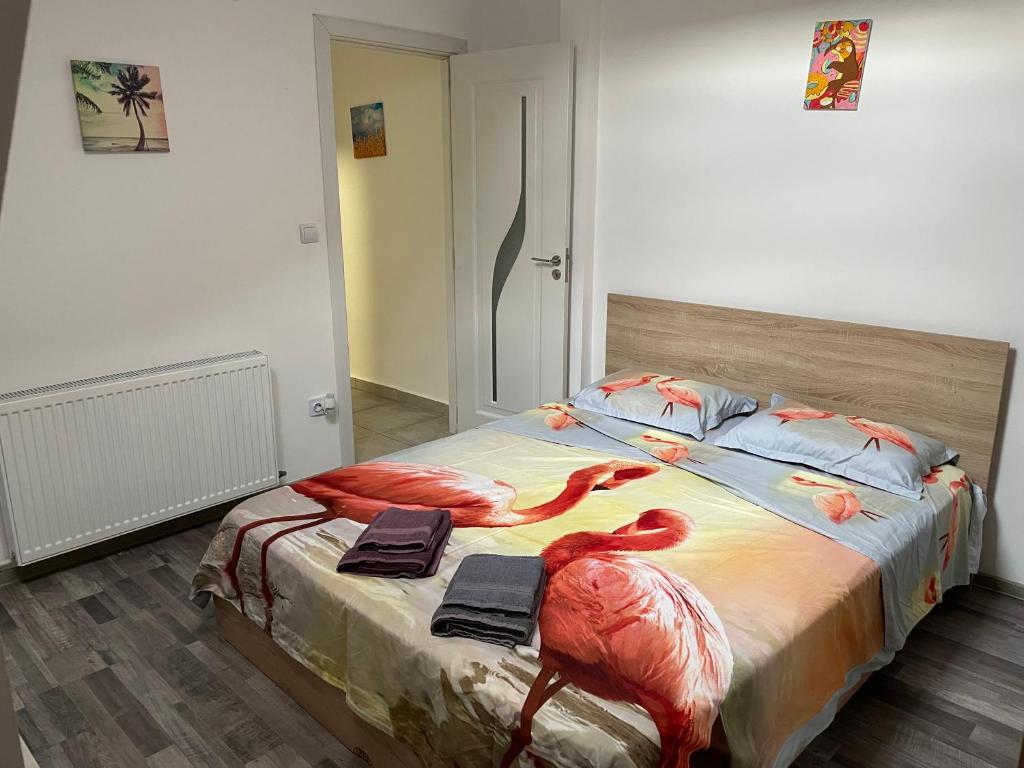a bedroom with a bed with two flamingos on it at New and modern, 2 rooms cozy apartment in Timişoara