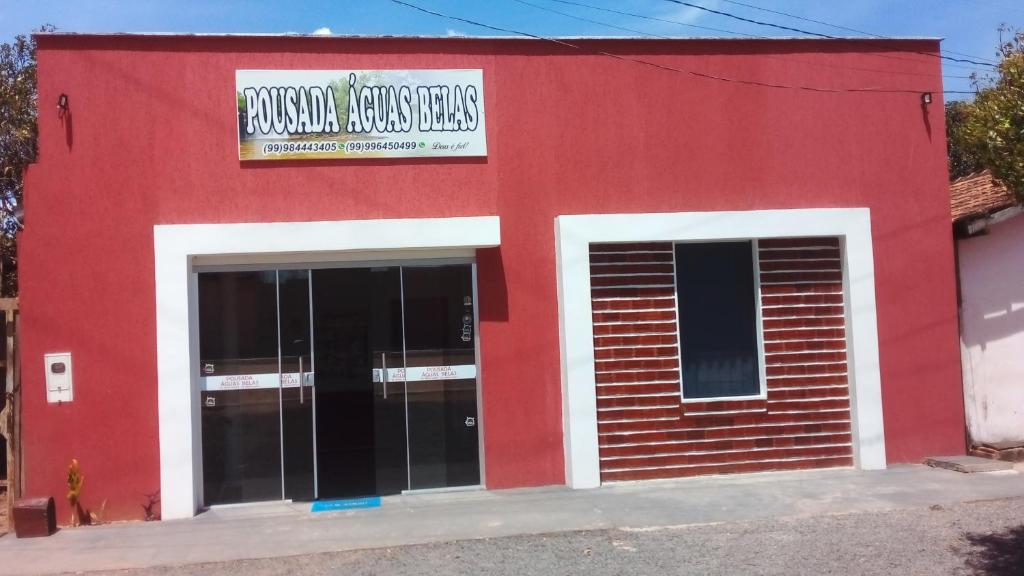 a red building with two doors and a sign on it at Pousada águas belas in Carolina