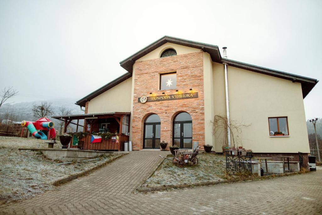 a building with a clock on the side of it at Pension Vyhlídka in Klášterec nad Ohří