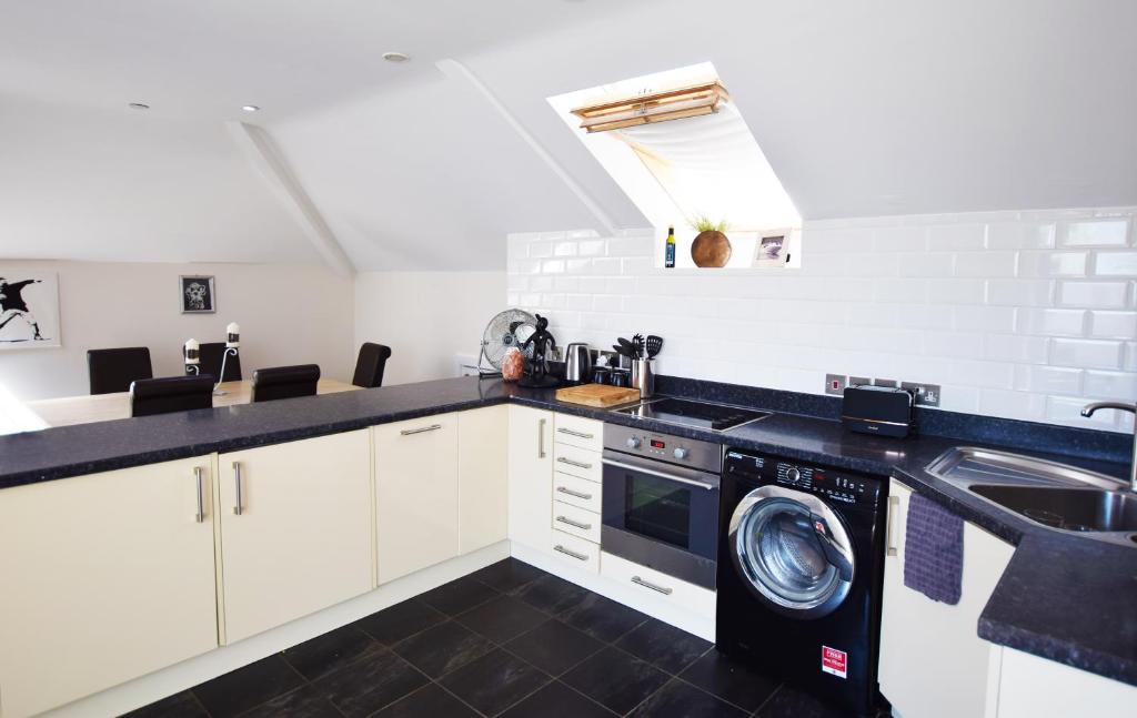 a kitchen with a washing machine and a sink at 15 Crabshell Heights in Kingsbridge