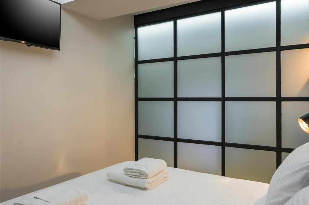 A bed or beds in a room at Skins Concept Boutique Apartment