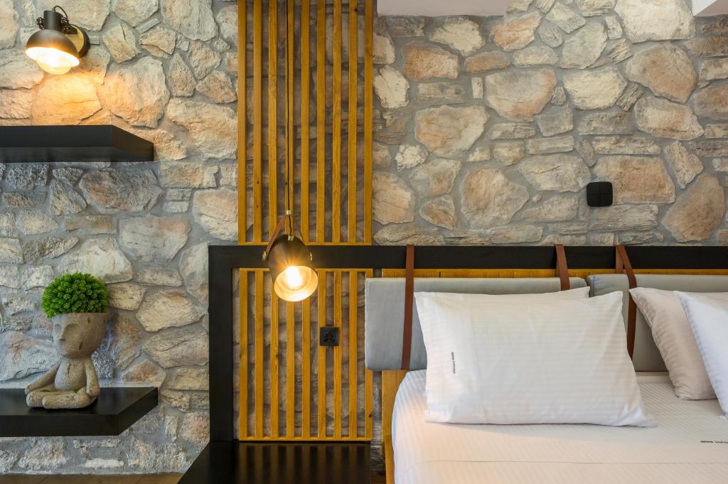 A bed or beds in a room at Skins Concept Boutique Apartment