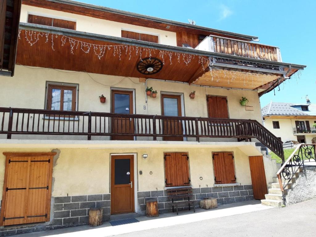 a house with wooden doors and a balcony at Appartement Albiez-Montrond, 2 pièces, 5 personnes - FR-1-618-5 in Albiez-Montrond