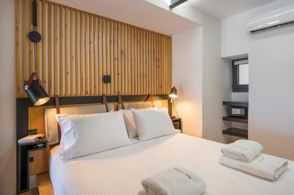 A bed or beds in a room at Skins Concept Boutique Apartment