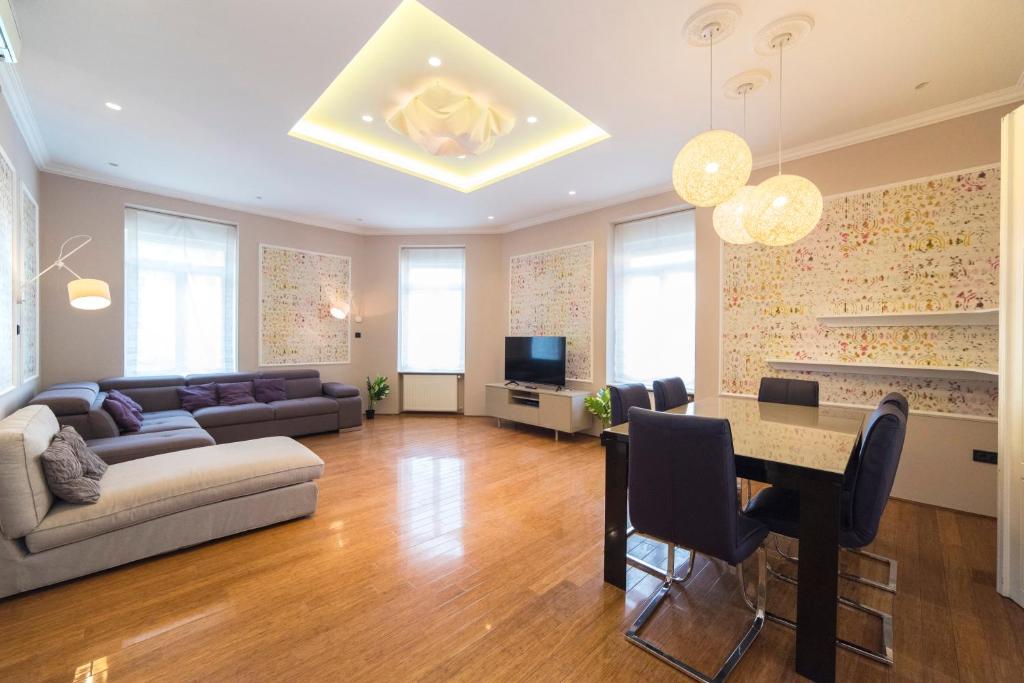 a living room with a couch and a table with chairs at Agape Apartments in Zagreb