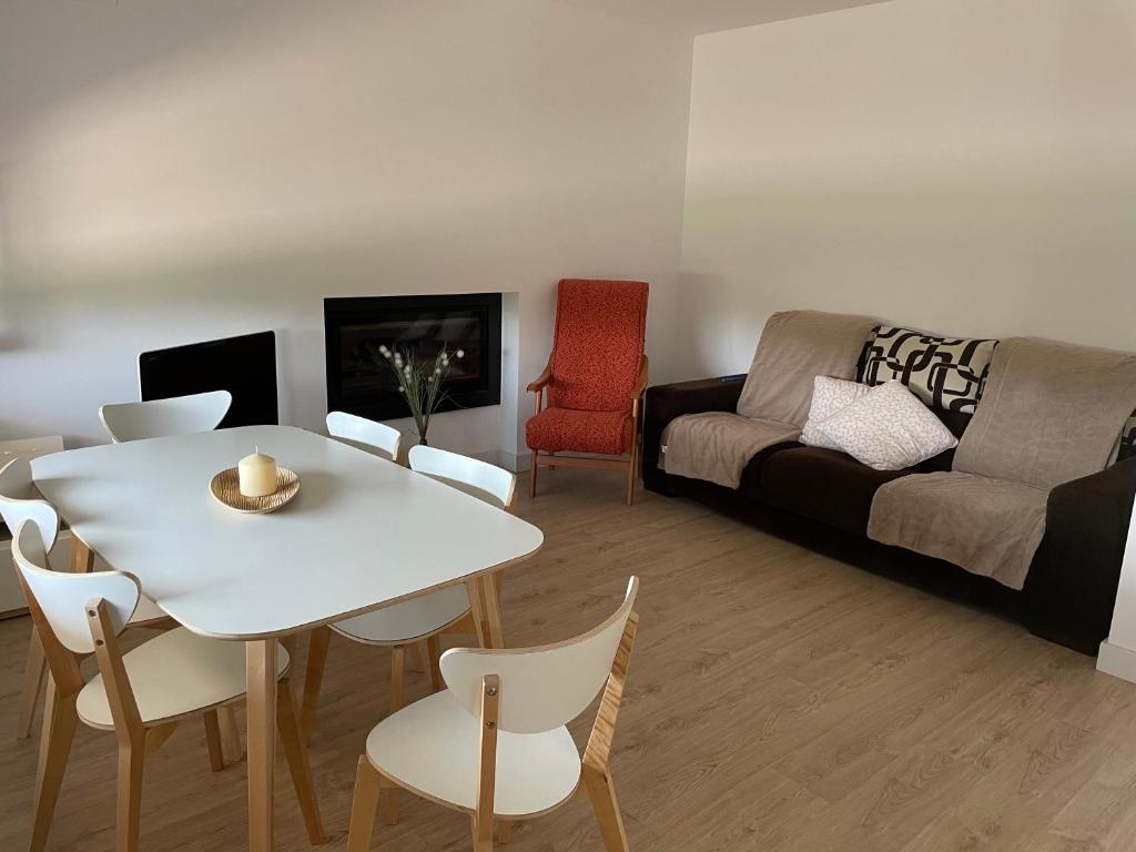 a living room with a table and a couch at Casa rural, Mas de Joan i Cinta in Sant Jaume d'Enveja