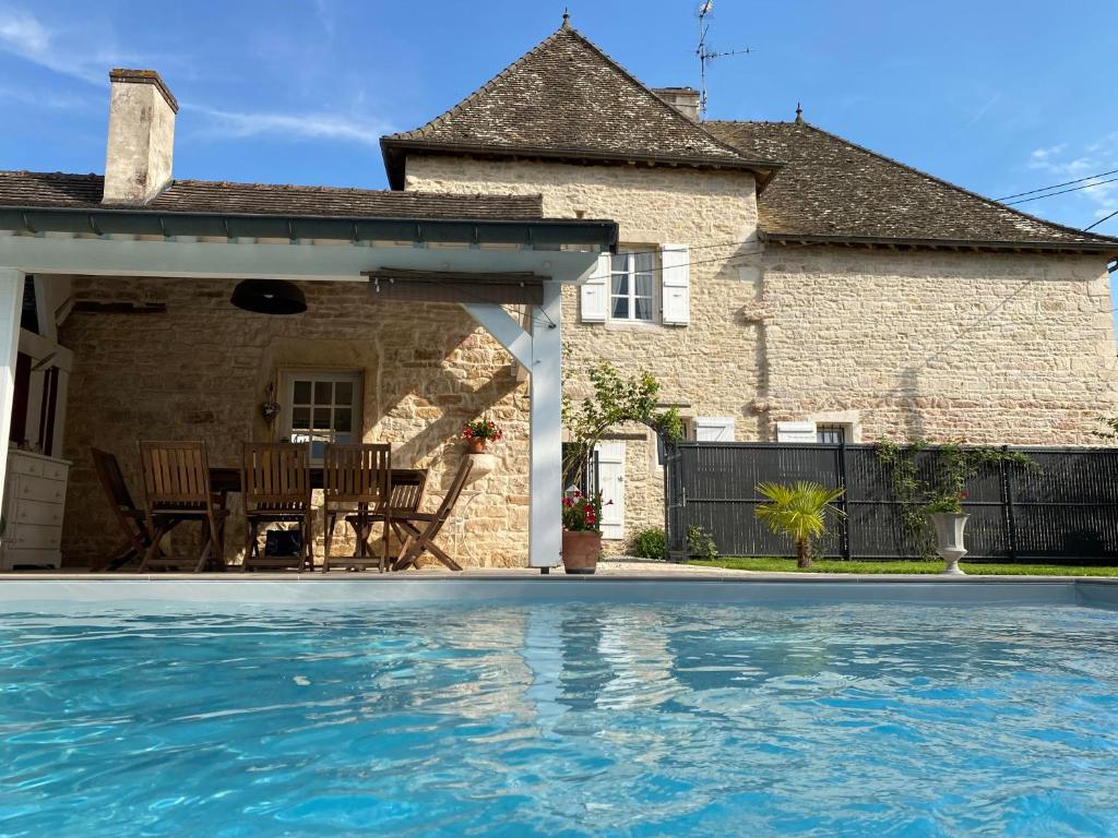 uma casa com piscina em frente a uma casa em Le pigeonnier de Saint-Loup Bed and Breakfast em Saint-Loup-de-Varenne