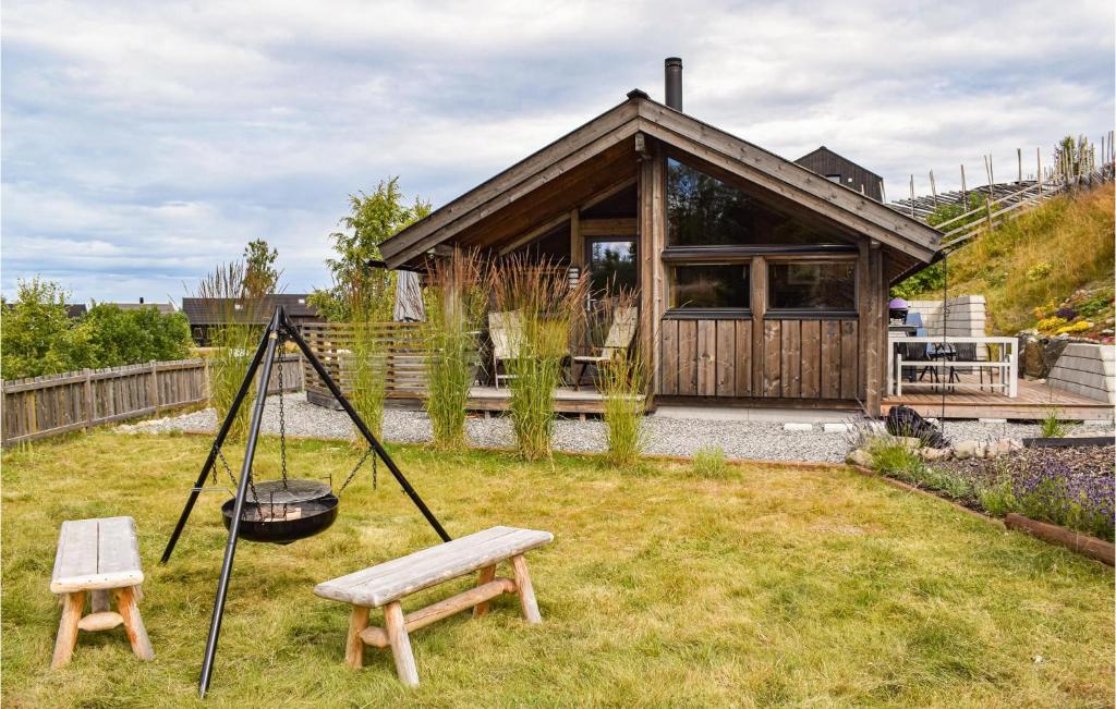 a house with a swing and a bench in a yard at Amazing Home In Espa With Wifi in Ulven