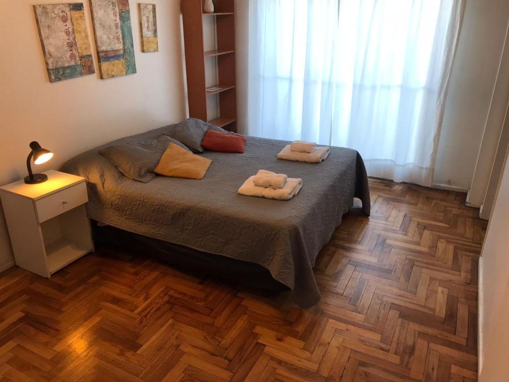 a bedroom with a bed with two towels on it at Departamento en Recoleta muy luminoso Piso 10 in Buenos Aires