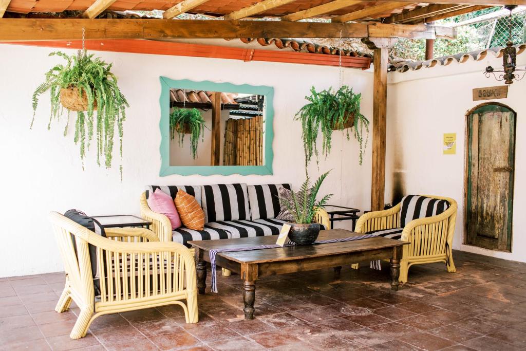 a patio with a couch and chairs and a table at Casi Casa in Antigua Guatemala