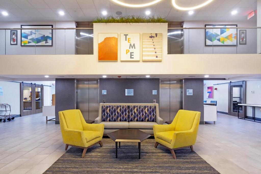 een lobby met 2 stoelen en een bank bij Holiday Inn Express & Suites Phoenix - Tempe, an IHG Hotel in Tempe