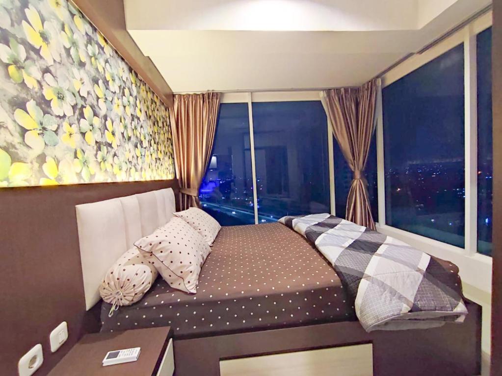 سرير أو أسرّة في غرفة في Grand Kamala Lagoon By Mitra Propertindo