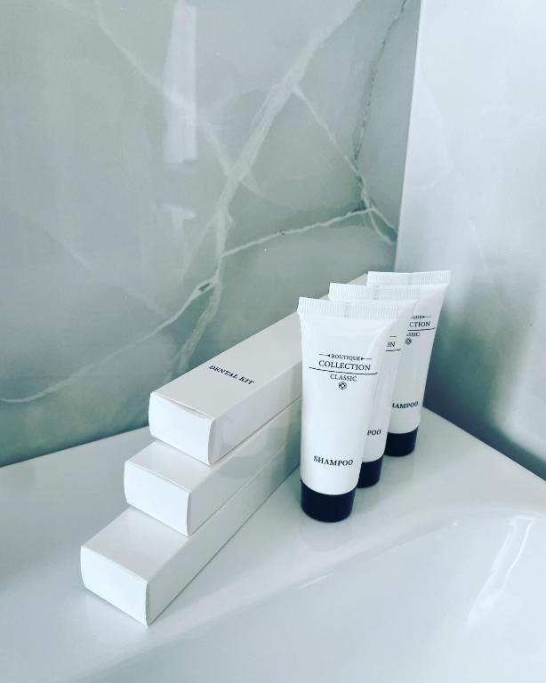 two white products sitting on top of a shelf at SEA & LAKE VIEW VILLA in (( Kalive Gjoka ))
