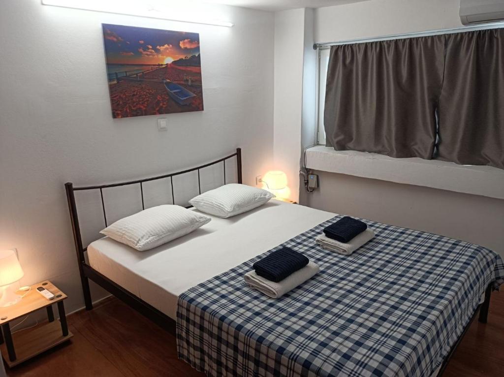 a bedroom with a bed with two pillows on it at Apartment Dipla in Athens