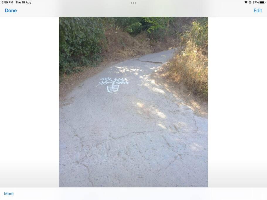 a road with a drawing of a bike on it at Manolates 360 views sea and mountains in Valeontádes