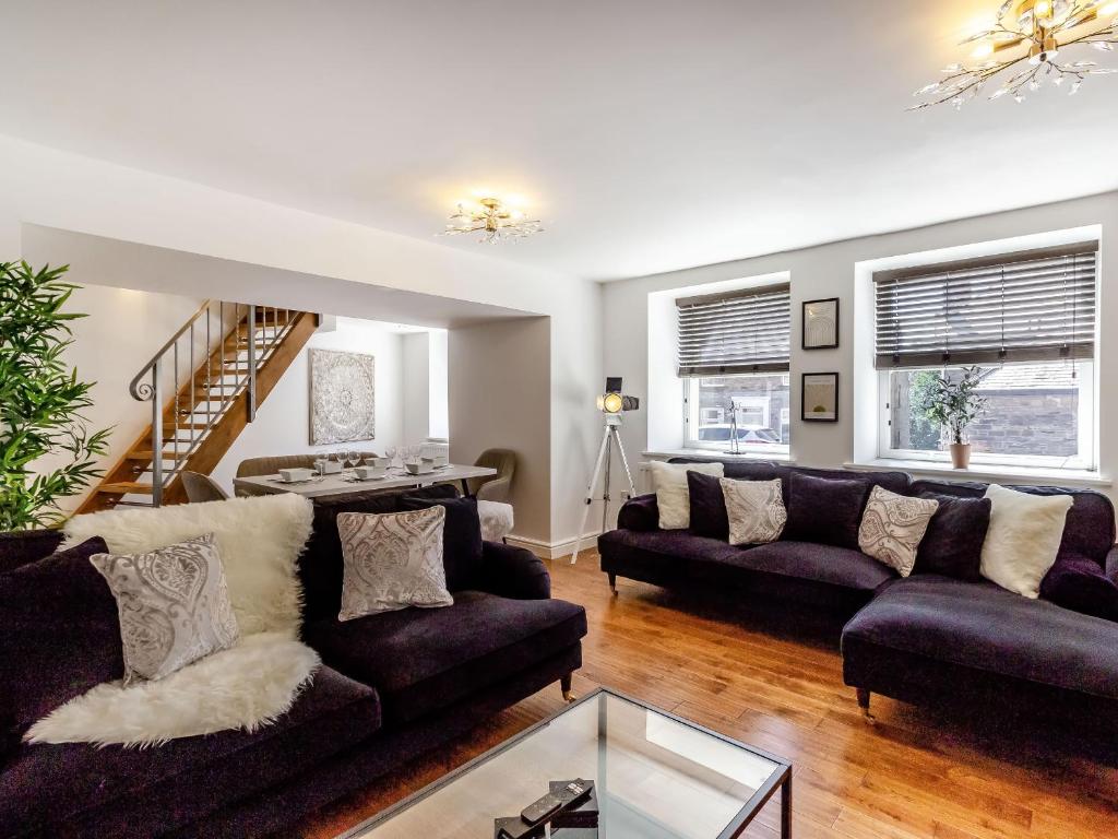 a living room with two couches and a table at Queen Anne Suite in Stanhope