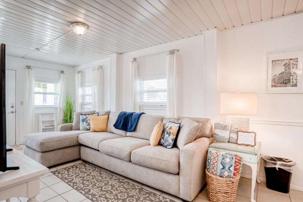 a living room with a couch and a table at Vilano Beach Oasis Bungalow in St. Augustine