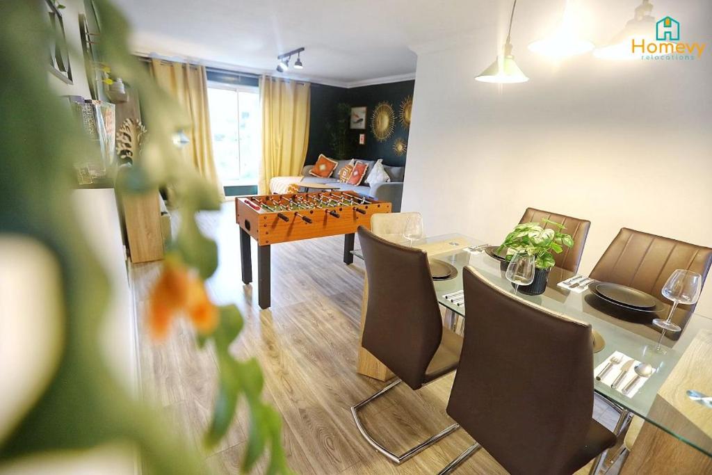 a living room with a table and chairs at Stylish 3 bedroom house - Homevy Relocations in Birmingham