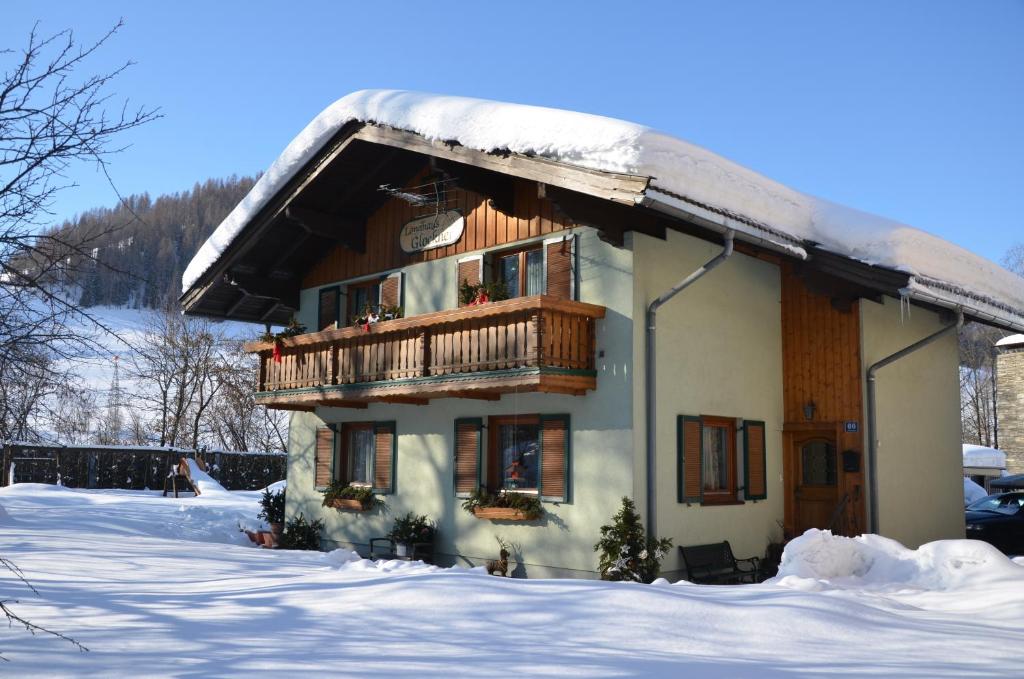 ein Haus mit Balkon im Schnee in der Unterkunft Landhaus Glockner in Bruck an der Großglocknerstraße