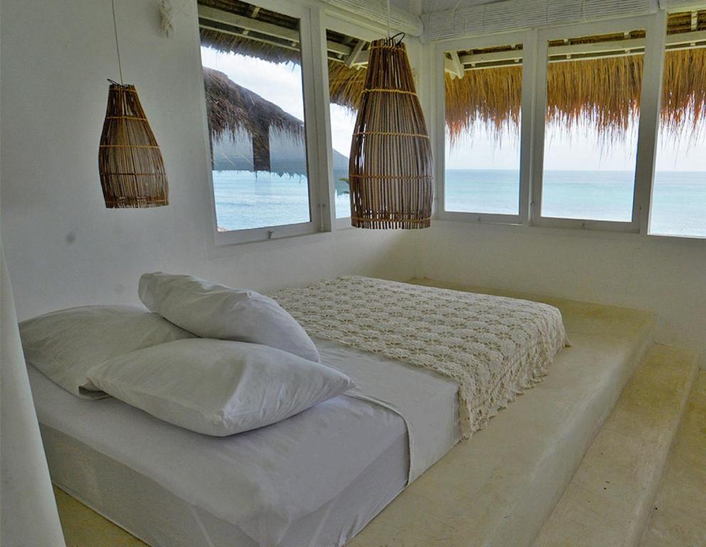 a bedroom with a bed with a view of the ocean at Sal Secret Spot in Uluwatu