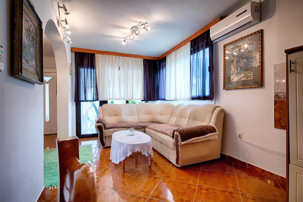 a living room with a couch and a table at Apartments with a parking space Komiza, Vis - 12325 in Komiža