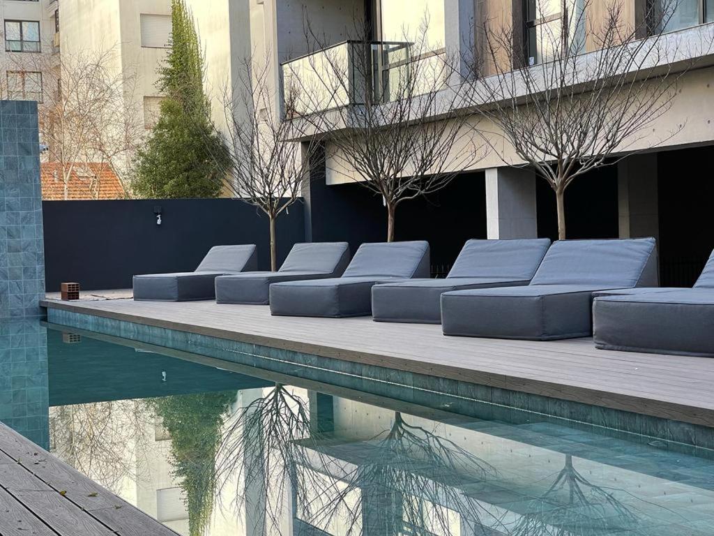 a group of pillows sitting next to a swimming pool at 304 San Lorenzo in Mar del Plata