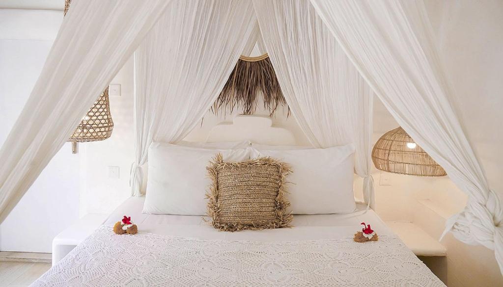 a white canopy bed with two teddy bears sitting on it at Sal Secret Spot in Uluwatu