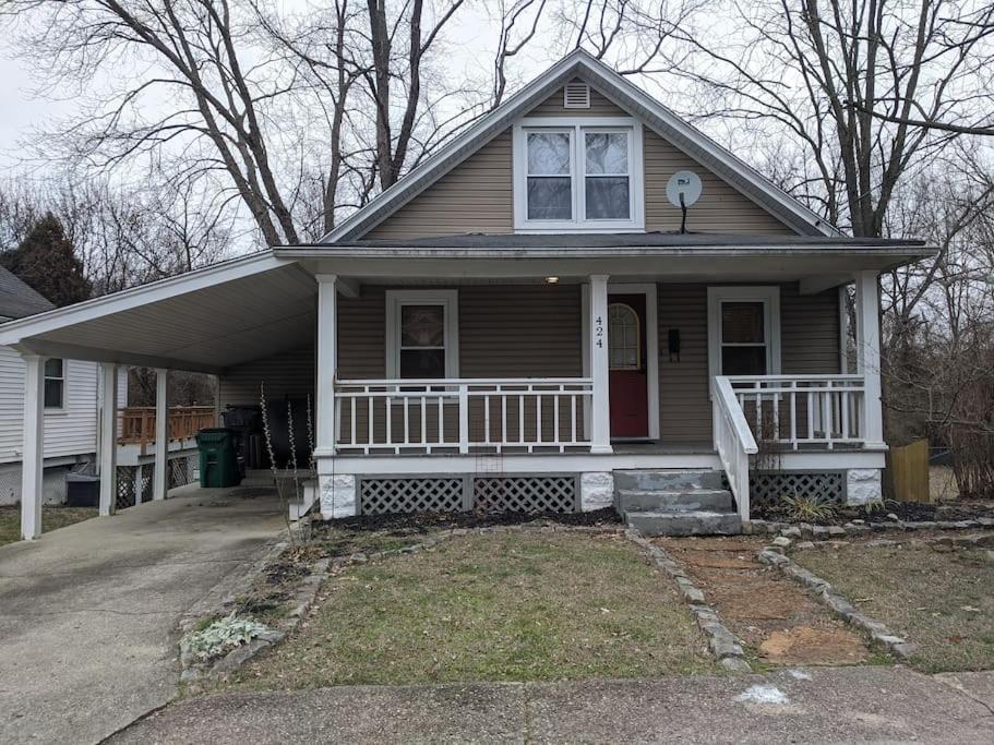 una pequeña casa con porche y puerta roja en Ohio Ave 3 bed house Historic Downtown Loveland, en Loveland