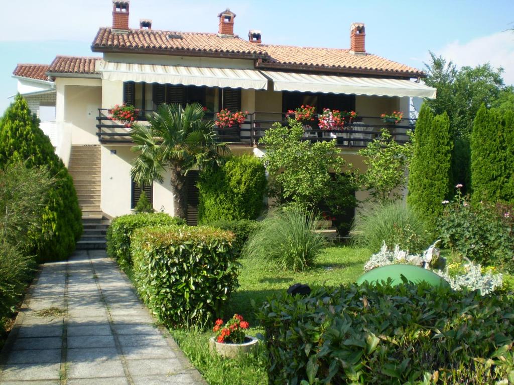 a house with a garden in front of it at Apartments for families with children Blaskovici, Central Istria - Sredisnja Istra - 12398 in Kršan