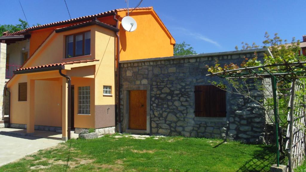 a small house with a stone wall at Family friendly house with a parking space Presika, Labin - 12472 in Labin