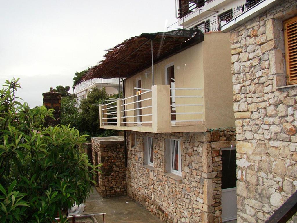 a building with a balcony on the side of it at Holiday house with a parking space Borje, Peljesac - 12506 in Orebić