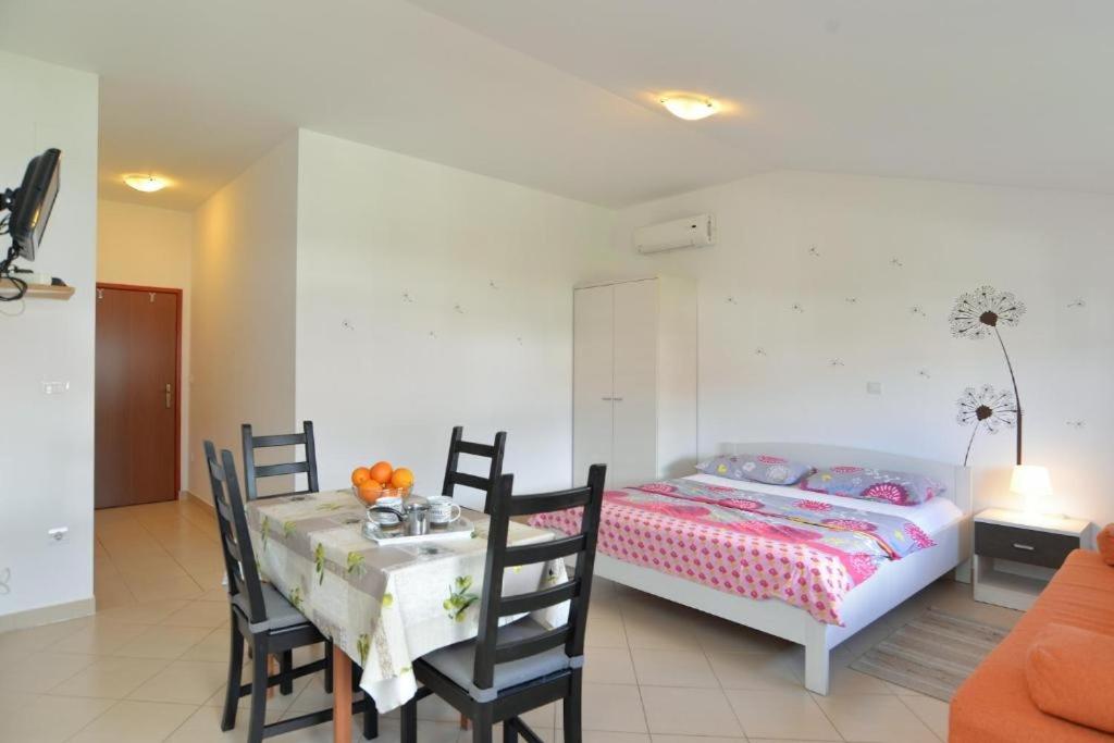 a bedroom with a bed and a table and chairs at Apartments with WiFi Fazana - 12862 in Marana