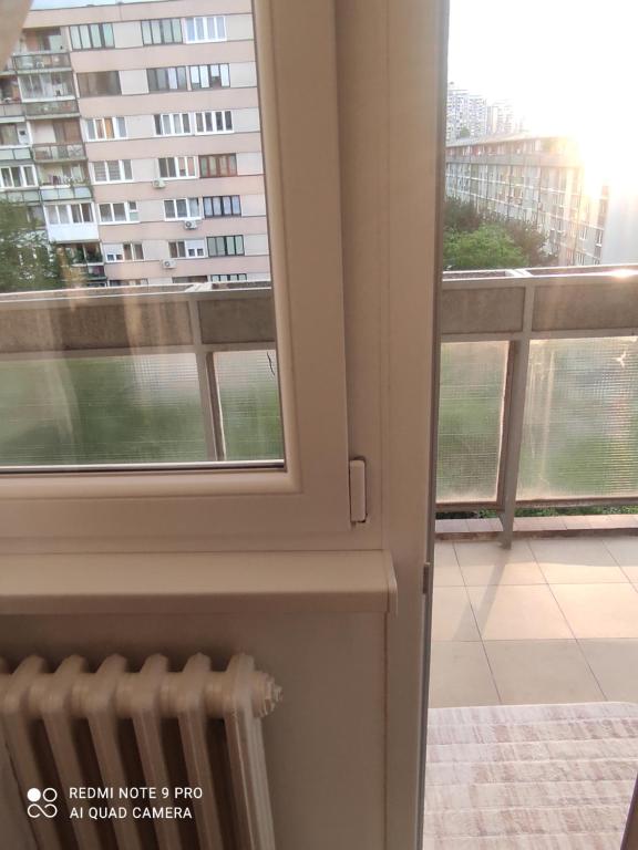 a room with a window and a radiator next to a building at Grbavica in Sarajevo