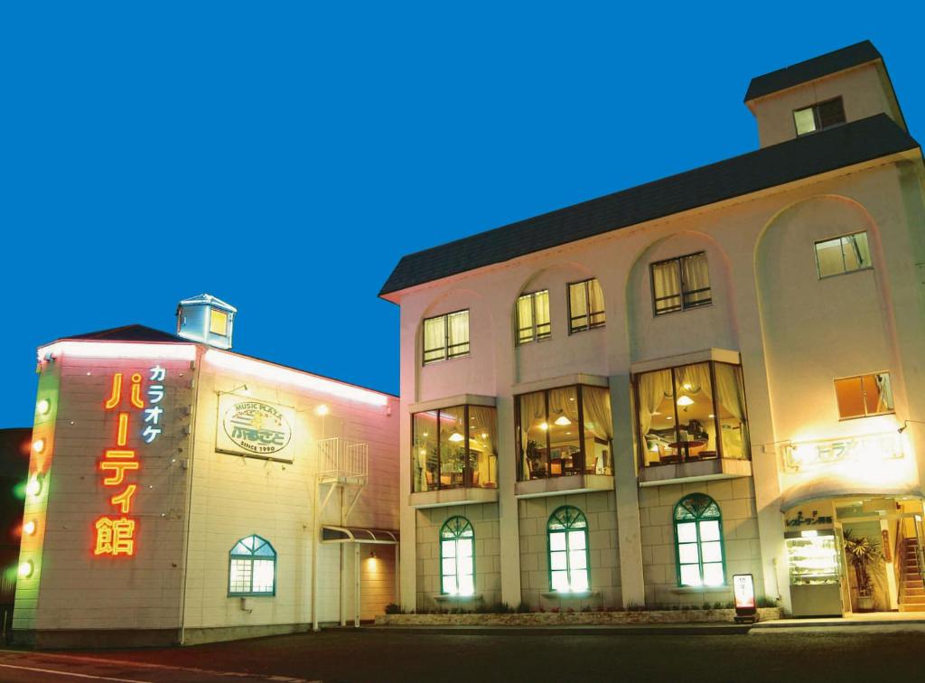 a building with a sign on the side of it at Business Hotel Furusato in Ibusuki