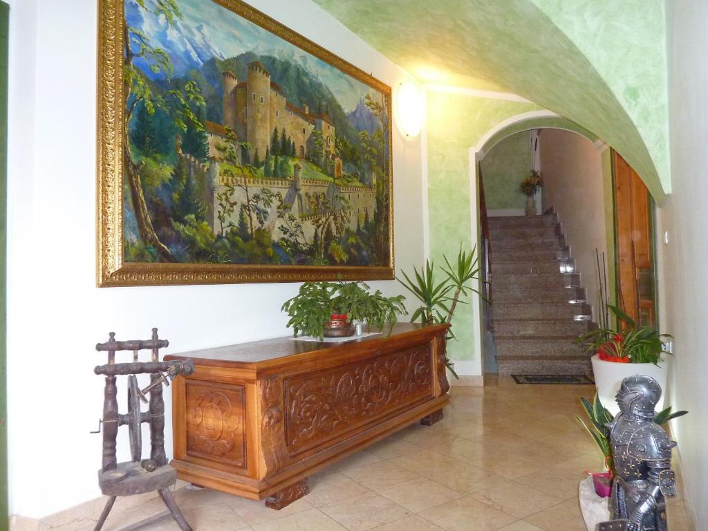 a hallway with a painting on the wall and a staircase at Appartamento Stumiaga di Fiavè in Fiavè