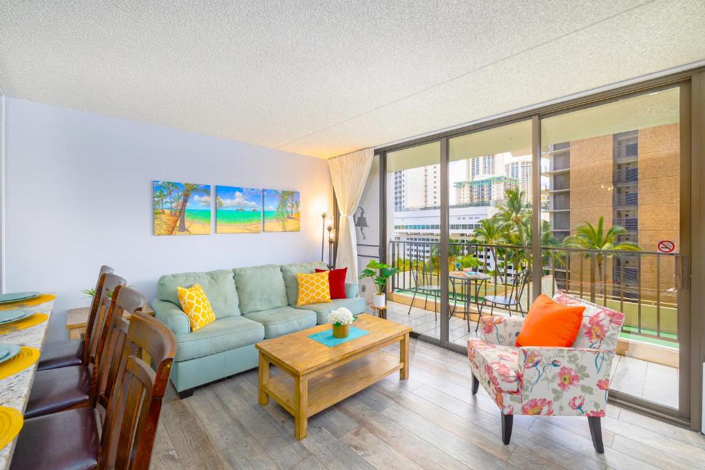 a living room with a couch and a table at Remodeled 1BR Condo, Steps to Beach, Free Parking! in Honolulu