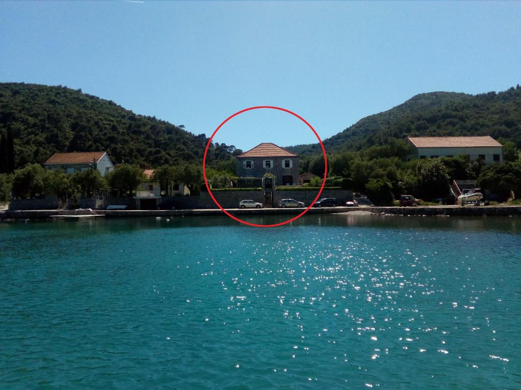 a house in the middle of a body of water at Apartments by the sea Broce, Peljesac - 13182 in Ston