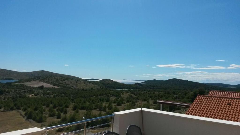 a balcony with a view of the mountains at Apartments with a parking space Grebastica, Sibenik - 13365 in Bašelovići