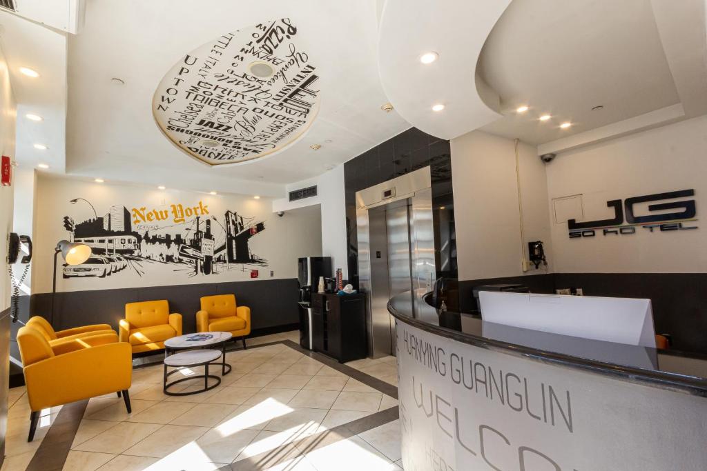 a lobby with yellow chairs and a waiting room at JG Sohotel in New York