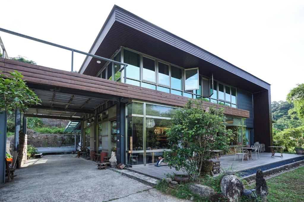 een zwart huis met veel ramen bij 小鳥敲門 Bird Villa in Shuangxi