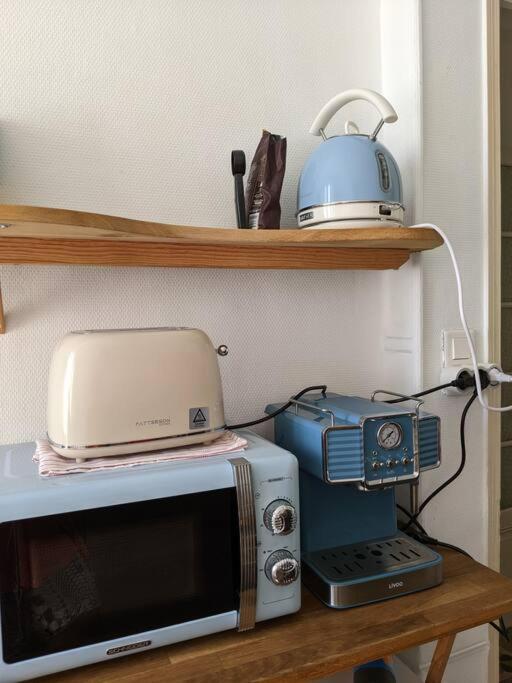 a microwave and a toaster on a table at Amazing 2-bedroom apartment in Nice near the beach in Nice
