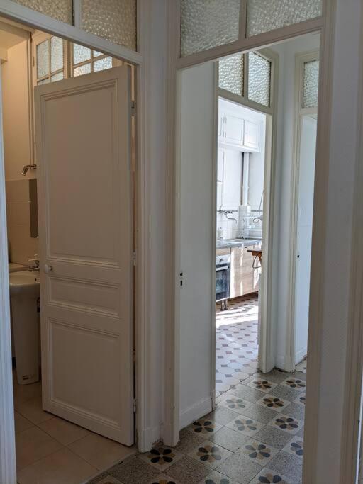 a hallway with two doors and a room with a window at Amazing 2-bedroom apartment in Nice near the beach in Nice