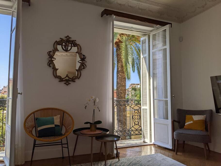 a room with a table and chairs and a balcony at Amazing 2-bedroom apartment in Nice near the beach in Nice