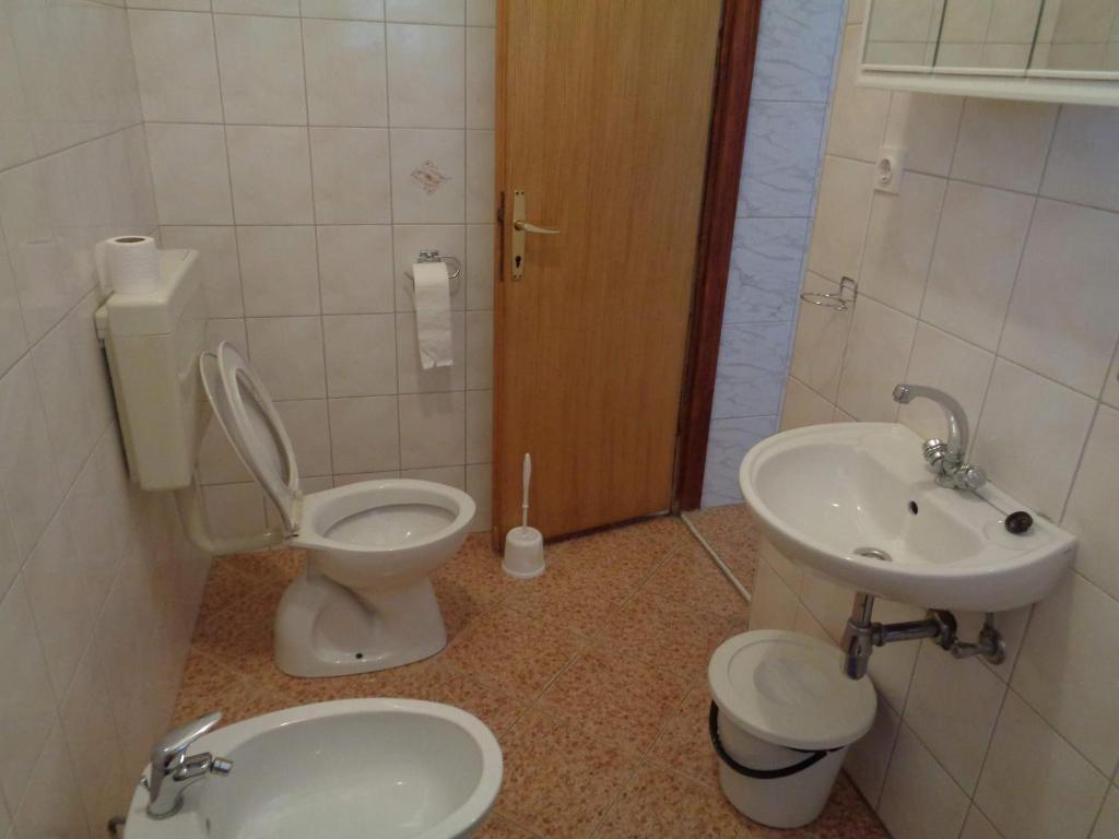 a bathroom with a toilet and a sink at Studio Sukosan 14681b in Sukošan
