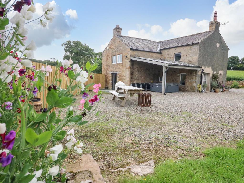 una vecchia casa in pietra con giardino e fiori di Box Tree Farm House a Lancaster