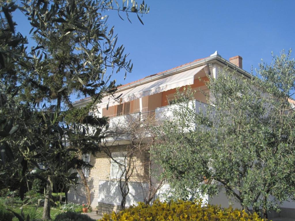 a building with trees in front of it at Apartments with a parking space Zadar - Diklo, Zadar - 14750 in Zadar