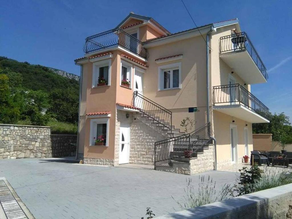 a large building with stairs and balconies on it at Family friendly apartments with a swimming pool Tribalj, Crikvenica - 14789 in Tribalj