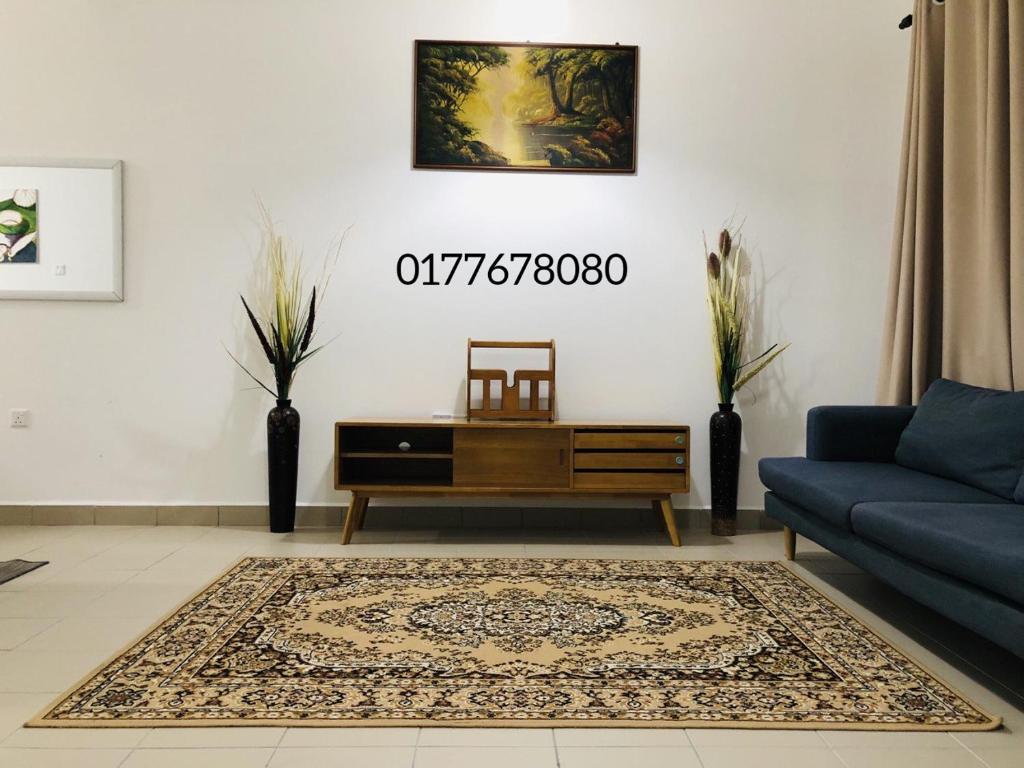 a living room with a couch and a coffee table at Alyn Home Batu Pahat IV Wifi Cuckoo in Batu Pahat